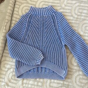 Distressed knitted sweater.